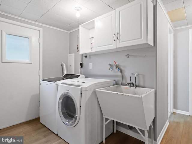 5415 Juliet St, Springfield, VA 22151 - laundry area featuring cabinet space, light wood-type flooring, and washer and clothes dryer