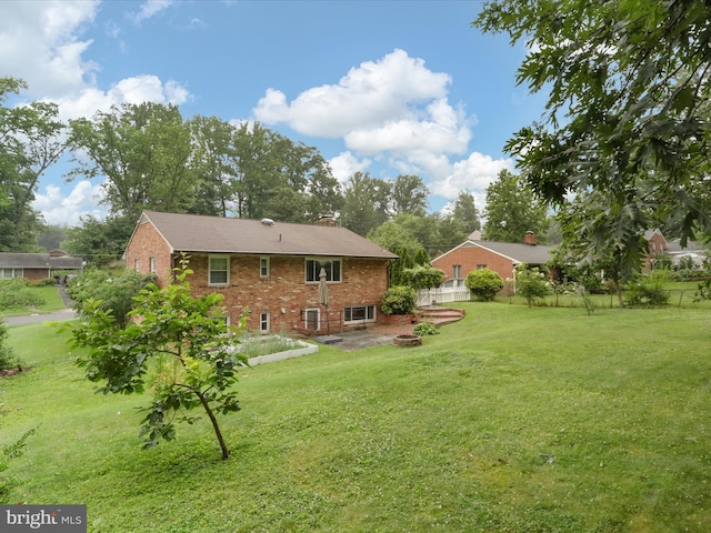 5415 Juliet St, Springfield, VA 22151 - rear view of property with brick siding, a chimney, and a fire pit