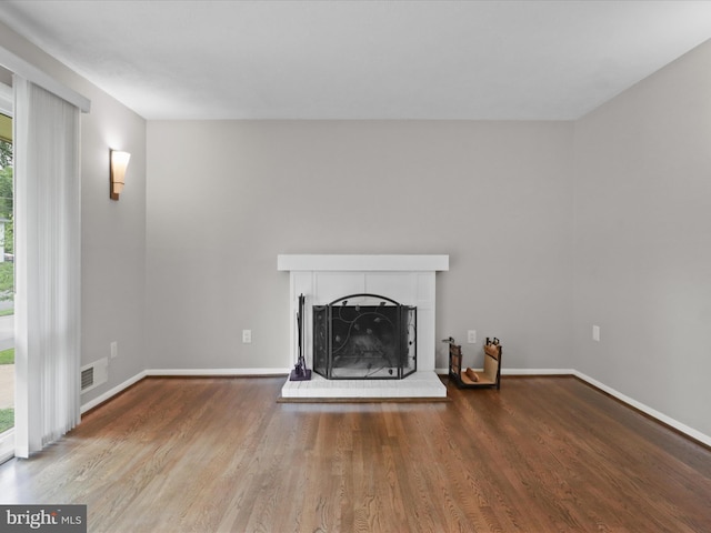 5415 Juliet St, Springfield, VA 22151 - unfurnished living room featuring healthy amount of natural light, a fireplace with raised hearth, and wood finished floors