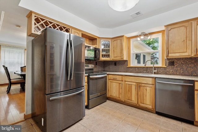 4133 Dana Ln, Lafayette Hill, PA 19444 - kitchen with appliances with stainless steel finishes, decorative backsplash, glass insert cabinets, and light tile patterned floors