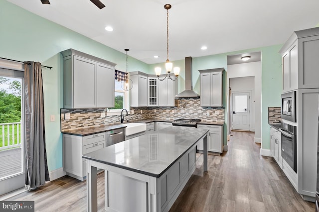 7 Compton Way, Barto, PA 19504 - kitchen featuring wall chimney range hood, appliances with stainless steel finishes, a chandelier, healthy amount of natural light, and recessed lighting