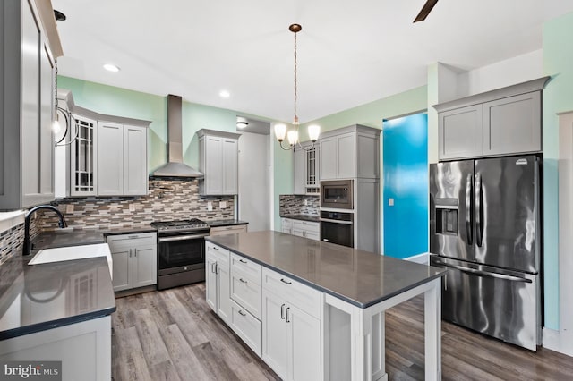 7 Compton Way, Barto, PA 19504 - kitchen with stainless steel appliances, wall chimney range hood, dark countertops, wood finished floors, and glass insert cabinets