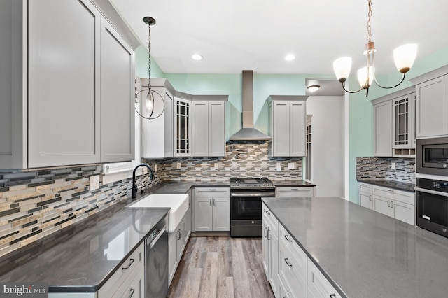 7 Compton Way, Barto, PA 19504 - kitchen featuring stainless steel appliances, wall chimney range hood, tasteful backsplash, a chandelier, and pendant lighting