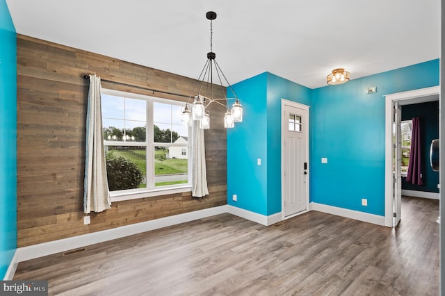 7 Compton Way, Barto, PA 19504 - unfurnished dining area with plenty of natural light, wood finished floors, a chandelier, and wooden walls