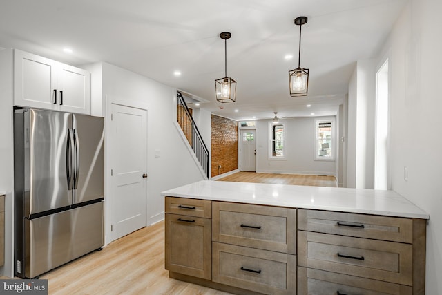 221 Ford St, Conshohocken, PA 19428 - kitchen featuring freestanding refrigerator, light wood finished floors, recessed lighting, decorative light fixtures, and a peninsula