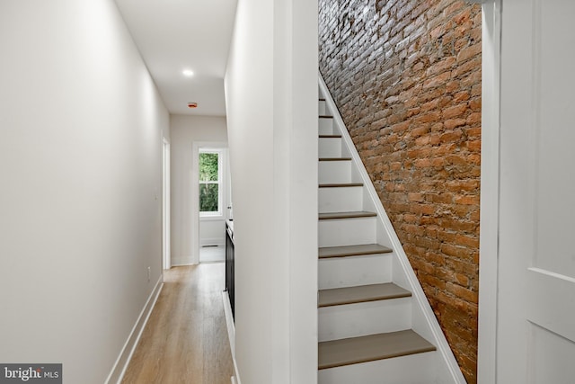 221 Ford St, Conshohocken, PA 19428 - stairs with brick wall, wood finished floors, and recessed lighting