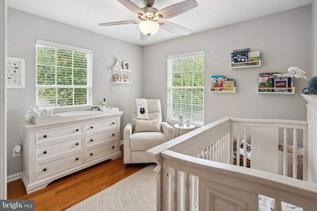 52 Ocean Breeze Ct, Manahawkin, NJ 08050 - bedroom with a crib, multiple windows, wood finished floors, and ceiling fan