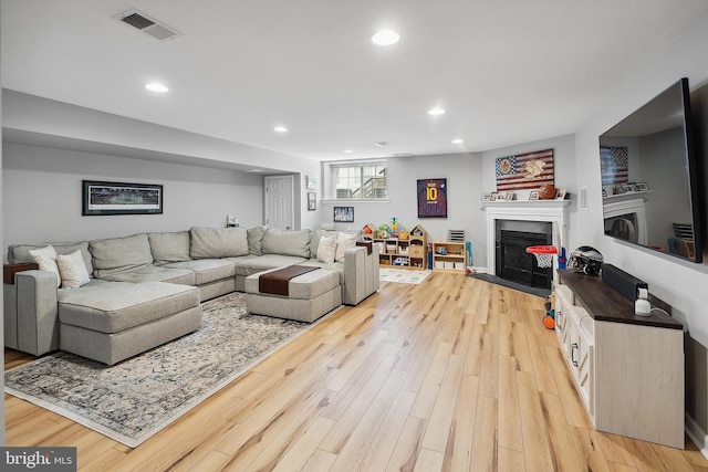 52 Ocean Breeze Ct, Manahawkin, NJ 08050 - living area featuring a fireplace with flush hearth, light wood-style floors, and recessed lighting