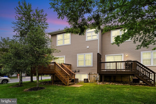 52 Ocean Breeze Ct, Manahawkin, NJ 08050 - back of house at dusk with stairway, a deck, and a lawn