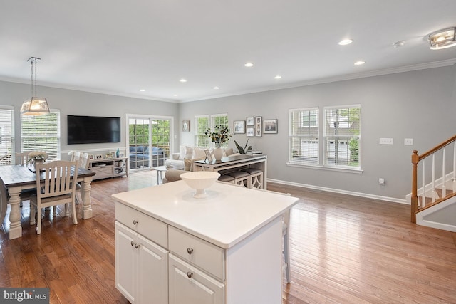 52 Ocean Breeze Ct, Manahawkin, NJ 08050 - kitchen featuring open floor plan, ornamental molding, white cabinets, a center island, and wood finished floors