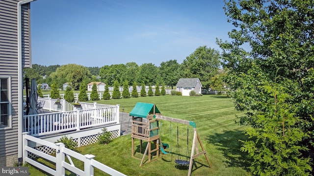 13474 Rustling Oaks Dr, Wye Mills, MD 21679 - view of green lawn featuring a playground, a deck, and a storage unit