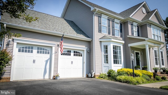 13474 Rustling Oaks Dr, Wye Mills, MD 21679 - view of side of property featuring asphalt driveway, roof with shingles, and an attached garage
