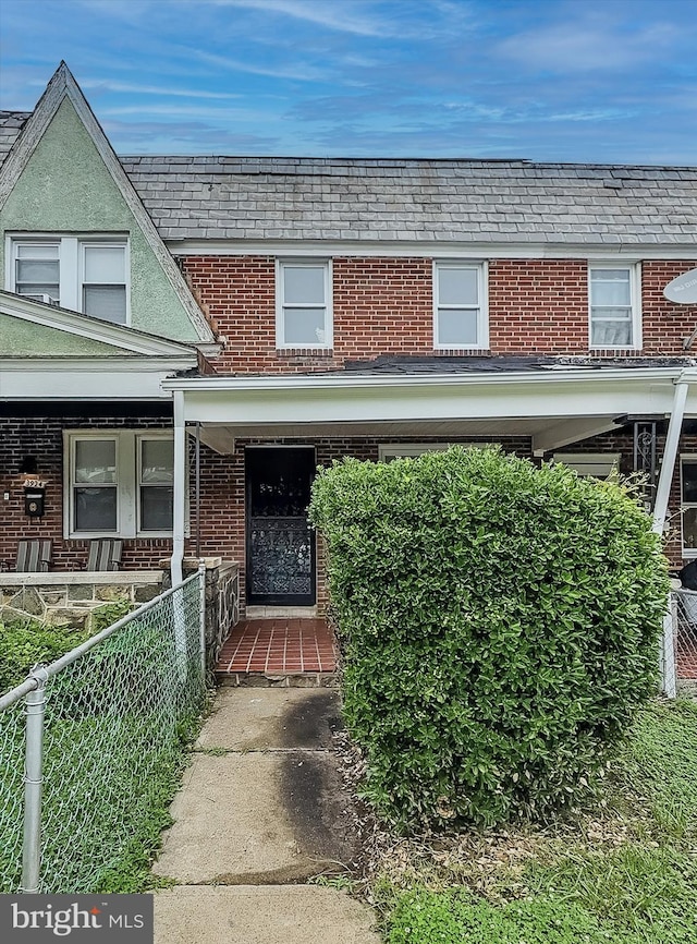 3922 Woodridge Rd, Baltimore, MD 21229 - view of front of house featuring brick siding, a high end roof, and covered porch