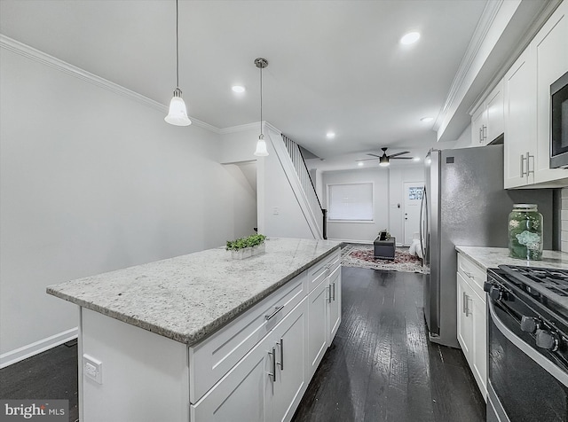 3922 Woodridge Rd, Baltimore, MD 21229 - kitchen featuring black gas stove, crown molding, a center island, white cabinetry, and ceiling fan
