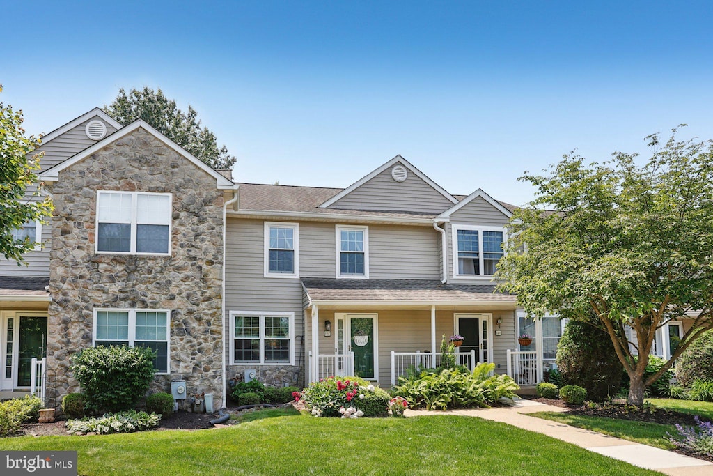 667 Shropshire Dr, West Chester, PA 19382 - view of front of property with stone siding, a front yard, and covered porch