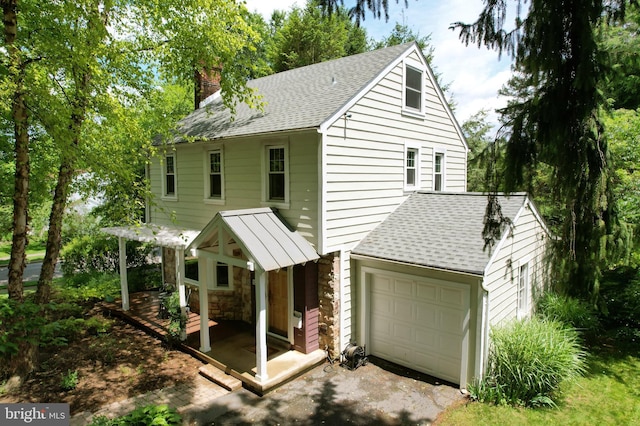 1203 Old Boalsburg Rd, State College, PA 16801 - view of front of home featuring a chimney, roof with shingles, asphalt driveway, and stone siding