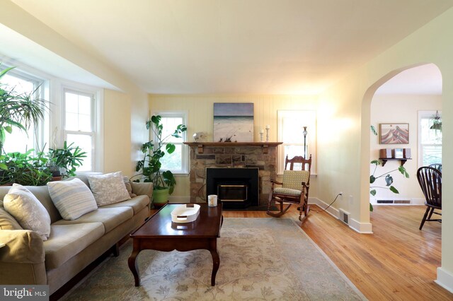 1203 Old Boalsburg Rd, State College, PA 16801 - living room with arched walkways, wood finished floors, and a fireplace