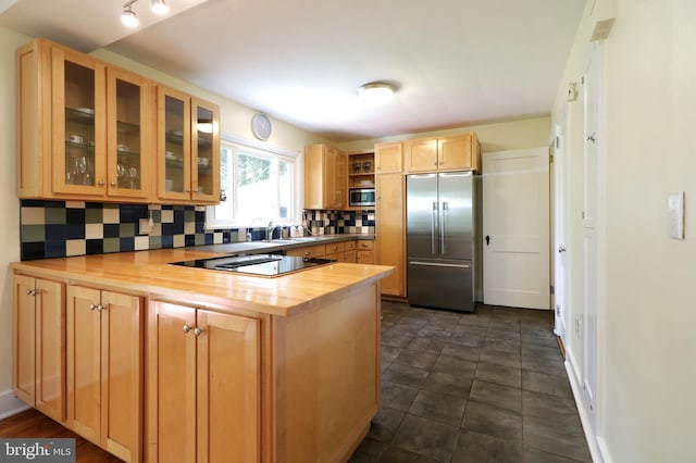 1203 Old Boalsburg Rd, State College, PA 16801 - kitchen featuring built in appliances, a peninsula, decorative backsplash, glass insert cabinets, and light brown cabinetry