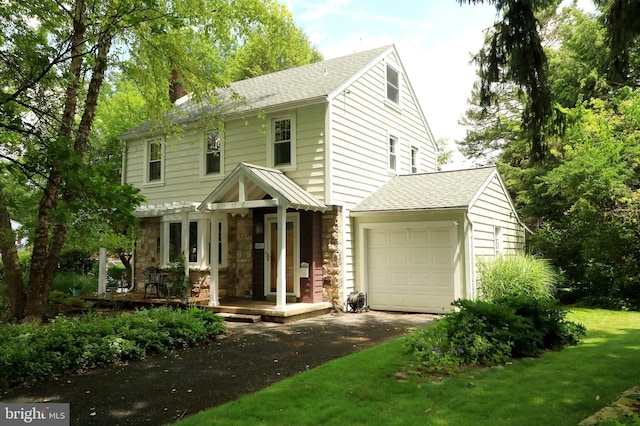 1203 Old Boalsburg Rd, State College, PA 16801 - view of front of house with driveway, a chimney, a garage, stone siding, and roof with shingles
