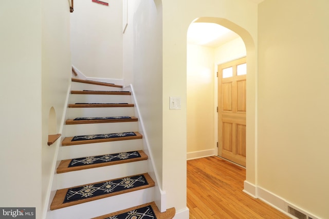 1203 Old Boalsburg Rd, State College, PA 16801 - staircase featuring arched walkways and wood finished floors