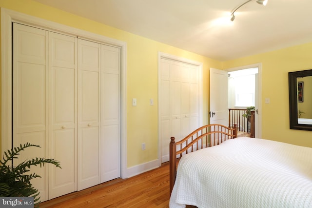 1203 Old Boalsburg Rd, State College, PA 16801 - bedroom featuring multiple closets, light wood-style flooring, and track lighting