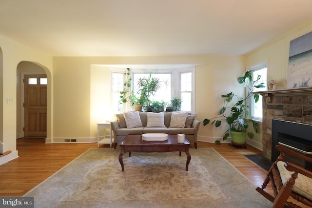 1203 Old Boalsburg Rd, State College, PA 16801 - living area with arched walkways, wood finished floors, and a fireplace