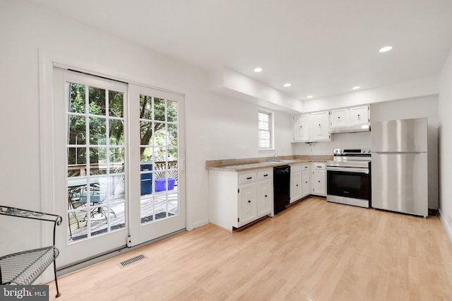 1951 Flowering Tree Ter, Silver Spring, MD 20902 - kitchen with stainless steel appliances, light countertops, light wood-style floors, under cabinet range hood, and recessed lighting