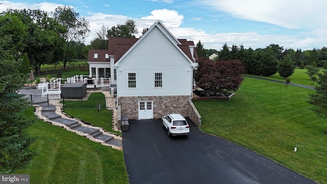 15901 Hampton Rd, Hamilton, VA 20158 - view of home's exterior with asphalt driveway, stone siding, an attached garage, and roof with shingles