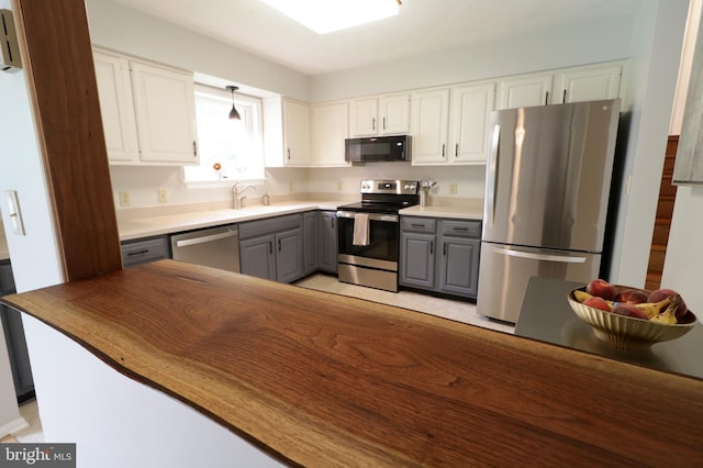 1239 Circleville Rd, State College, PA 16803 - kitchen with appliances with stainless steel finishes, gray cabinetry, white cabinetry, and hanging light fixtures