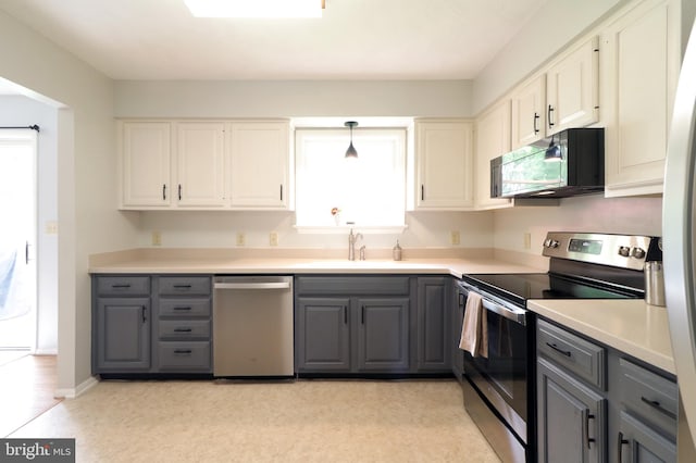 1239 Circleville Rd, State College, PA 16803 - kitchen featuring stainless steel appliances, gray cabinets, healthy amount of natural light, and light countertops