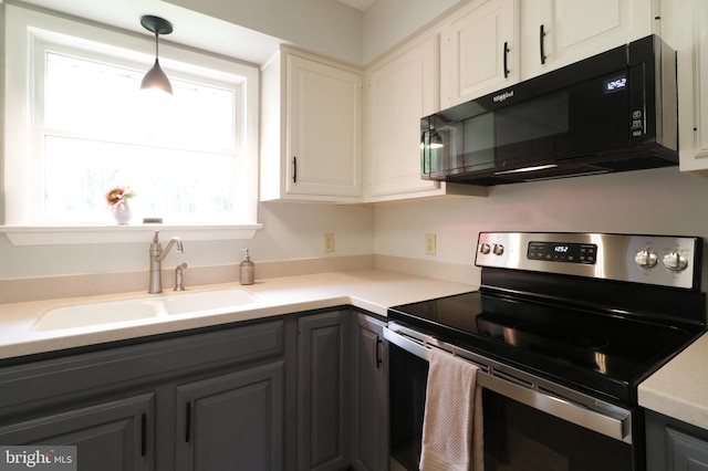 1239 Circleville Rd, State College, PA 16803 - kitchen featuring stainless steel electric range, black microwave, gray cabinets, light countertops, and decorative light fixtures