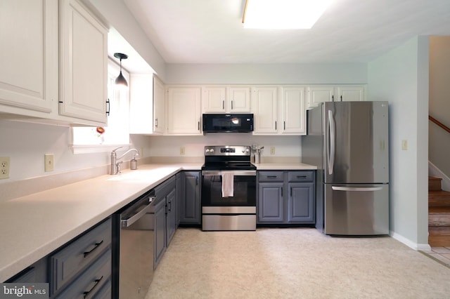1239 Circleville Rd, State College, PA 16803 - kitchen with appliances with stainless steel finishes, gray cabinets, white cabinets, light countertops, and light floors
