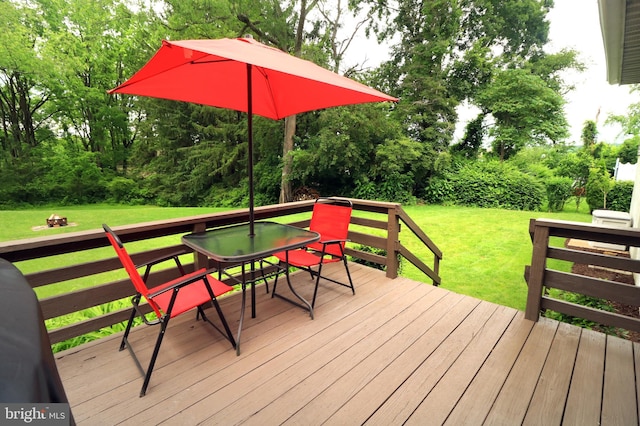 1239 Circleville Rd, State College, PA 16803 - deck featuring outdoor dining area, a yard, and view of wooded area