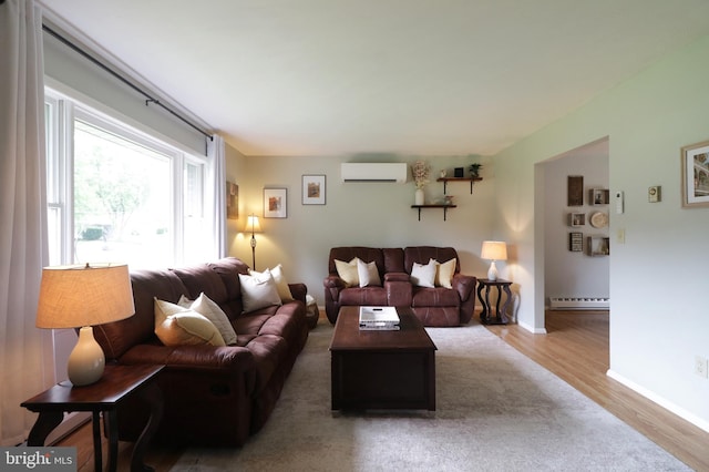 1239 Circleville Rd, State College, PA 16803 - living area featuring an AC wall unit, wood finished floors, and a baseboard heating unit