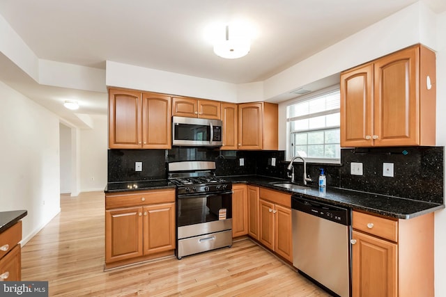 18432 Gardenia Way, Gaithersburg, MD 20879 - kitchen featuring stainless steel appliances, light wood finished floors, tasteful backsplash, dark stone countertops, and brown cabinets