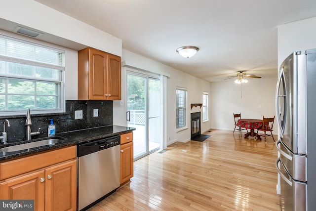 18432 Gardenia Way, Gaithersburg, MD 20879 - kitchen featuring stainless steel appliances, light wood finished floors, healthy amount of natural light, and backsplash