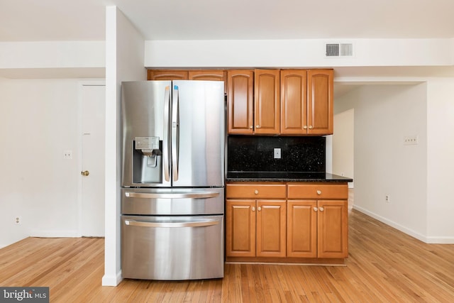 18432 Gardenia Way, Gaithersburg, MD 20879 - kitchen with stainless steel refrigerator with ice dispenser, light wood finished floors, backsplash, and brown cabinets