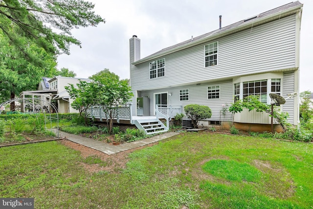 18432 Gardenia Way, Gaithersburg, MD 20879 - rear view of property with a chimney, a wooden deck, and a lawn