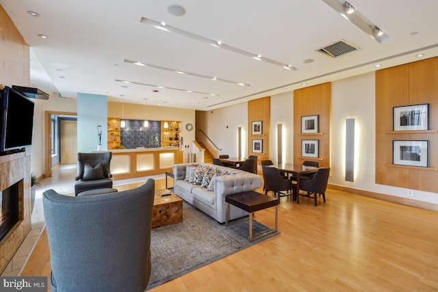 475 K St NW Unit 522, Washington, DC 20001 - living area with light wood-type flooring, a premium fireplace, and stairs