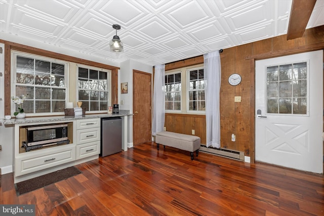 2 Forest Trl, Fairfield, PA 17320 - kitchen featuring refrigerator, stainless steel microwave, dark wood finished floors, an ornate ceiling, and wood walls