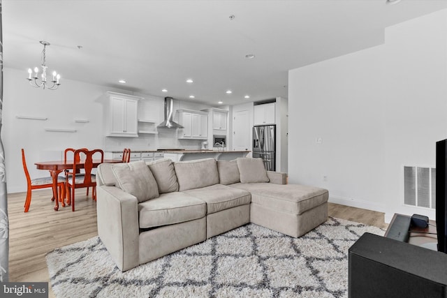 217 Hoke Farm Way, Mechanicsburg, PA 17050 - living room featuring a chandelier, recessed lighting, and light wood-type flooring