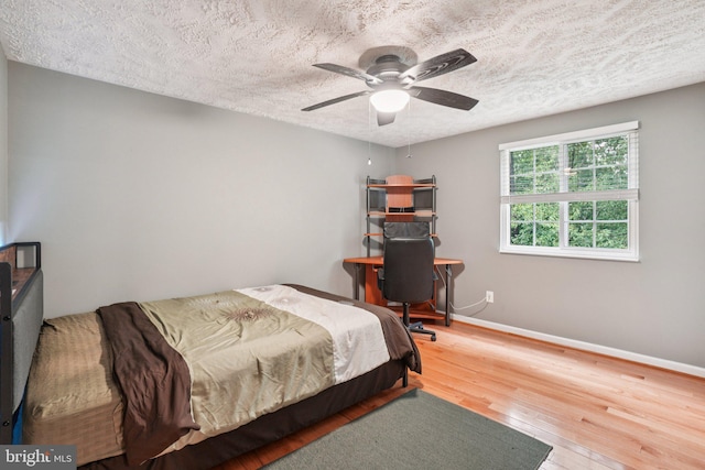16041 Macedonia Dr, Woodbridge, VA 22191 - bedroom featuring wood finished floors, a textured ceiling, and a ceiling fan