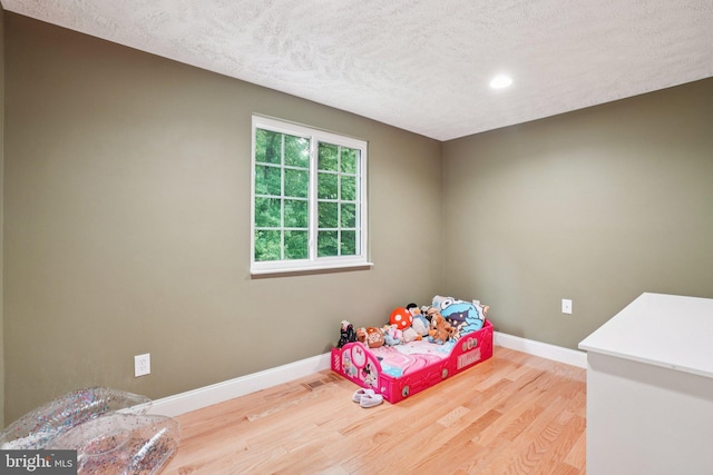 16041 Macedonia Dr, Woodbridge, VA 22191 - bedroom featuring wood finished floors, a textured ceiling, and recessed lighting