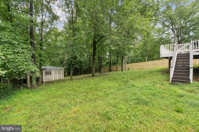 16041 Macedonia Dr, Woodbridge, VA 22191 - fenced backyard featuring stairs, a wooden deck, and a storage unit