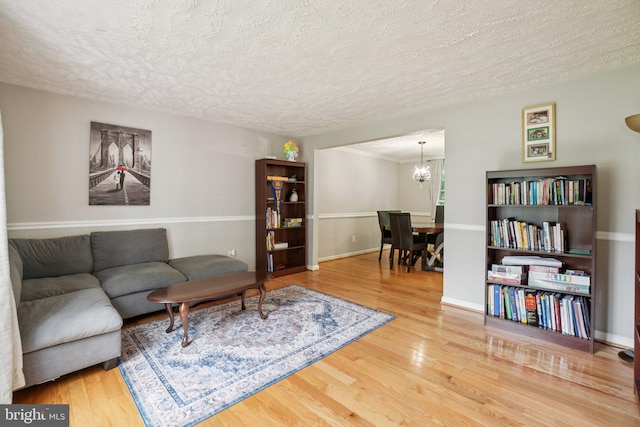 16041 Macedonia Dr, Woodbridge, VA 22191 - living room featuring a textured ceiling, a chandelier, and wood finished floors