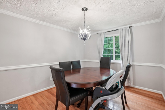 16041 Macedonia Dr, Woodbridge, VA 22191 - dining space featuring a textured ceiling, light wood-style flooring, a chandelier, and ornamental molding