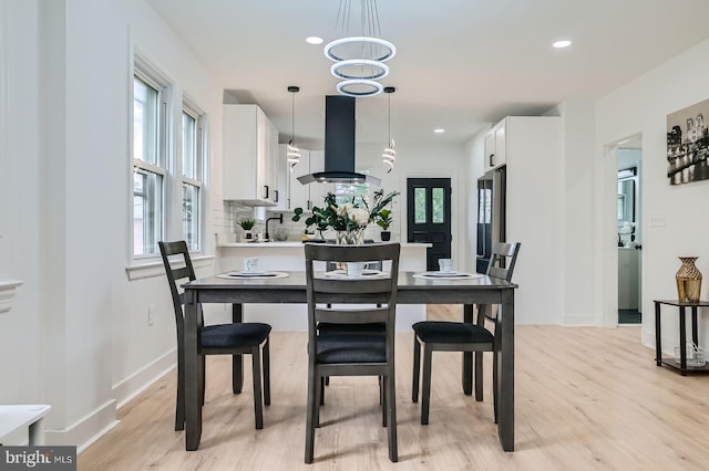 3814 Cedardale Rd, Baltimore, MD 21215 - dining area featuring light wood finished floors, recessed lighting, and a chandelier