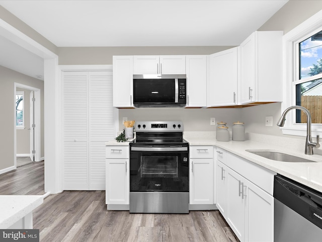 813 Ferguson Rd, Joppa, MD 21085 - kitchen with appliances with stainless steel finishes, white cabinetry, and light countertops