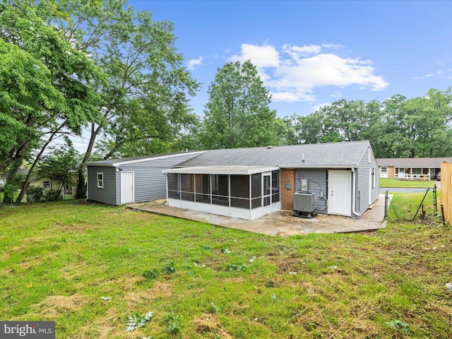 813 Ferguson Rd, Joppa, MD 21085 - rear view of house featuring a sunroom, a lawn, and a patio area