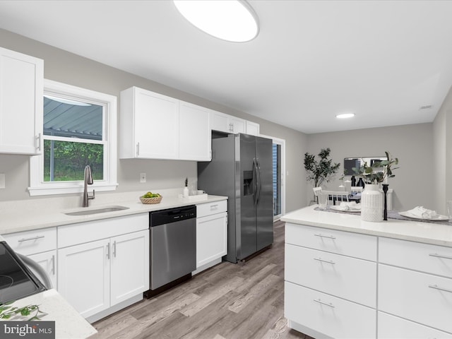 813 Ferguson Rd, Joppa, MD 21085 - kitchen featuring stainless steel appliances, white cabinetry, light countertops, and light wood-style floors